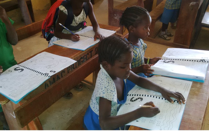 school pupils writing during CSR initiative program 